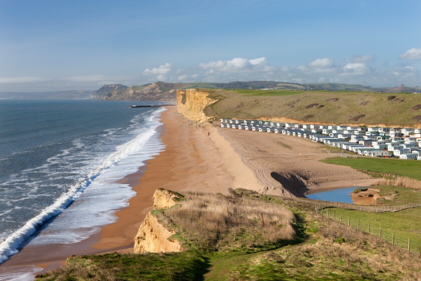 Static caravans with beach views on a coastal holiday park near Burton Bradstock, Dorset, England. Winter (February) 2011.
