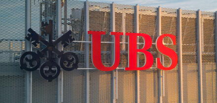 UBS logotype on the top of the UBS office during sunrise. UBS AG is a Swiss global financial services company with its headquarters in Zurich and Base