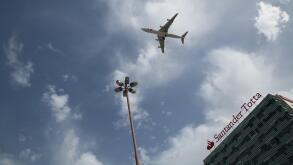 An aeroplane flying low over a hotel in Lisbon. Portugal.