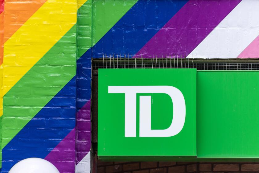 Business sign or logo of the Toronto Dominion or TD bank surrounded by Pride rainbow colors seen in the downtown district of Toronto city, Canada