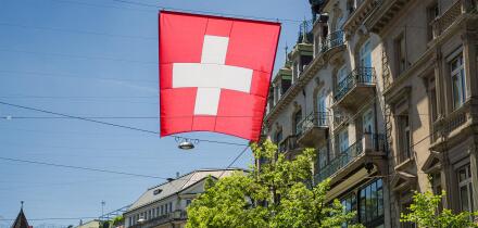 Swiss flag flying in streets of Zurich, Switzerland