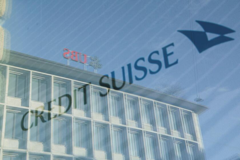 Logos of Swiss banks UBS and Credit Suisse are seen in Zurich, Switzerland March 20, 2023. REUTERS/Denis Balibouse