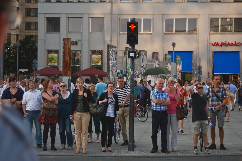 People at pedestrian crossing waiting for the green light. Berlin, Germany.