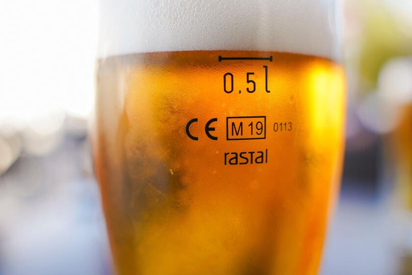 Cisal glass of full beer with CE Marking 0.5l  on table in Spain..