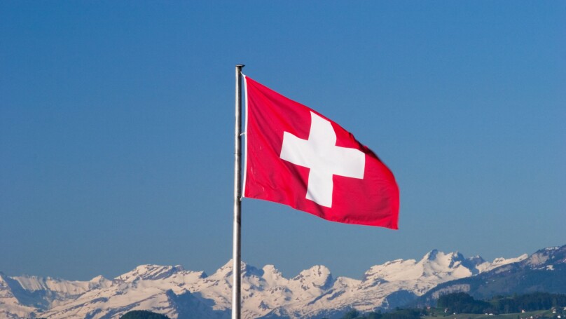 Swiss flag and Alps