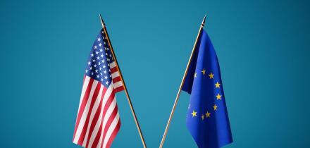 Transatlantic Partnership Concept. USA And European Union Flags Crossed On Golden Stand Against Blue Background. 3d Rendering