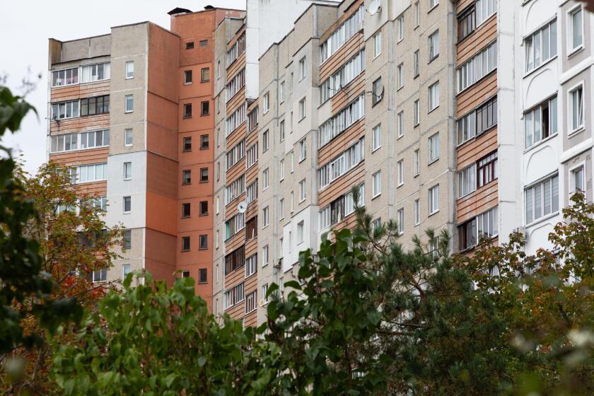 High-rise apartment buildings in a residential neighborhood showcasing rental and mortgage opportunities as autumn approaches
