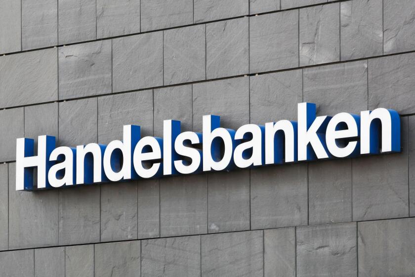 Aarhus, Denmark - August 7, 2020: Handelsbanken logo on a wall. Handelsbanken is a Swedish bank providing universal banking services