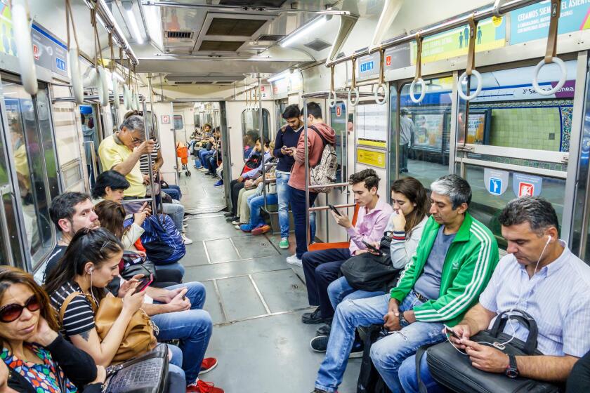 Buenos Aires Argentina,Subte subway train,inside,passenger passengers rider riders,man men male,woman female women,sitting,standing,smartphone cell ph