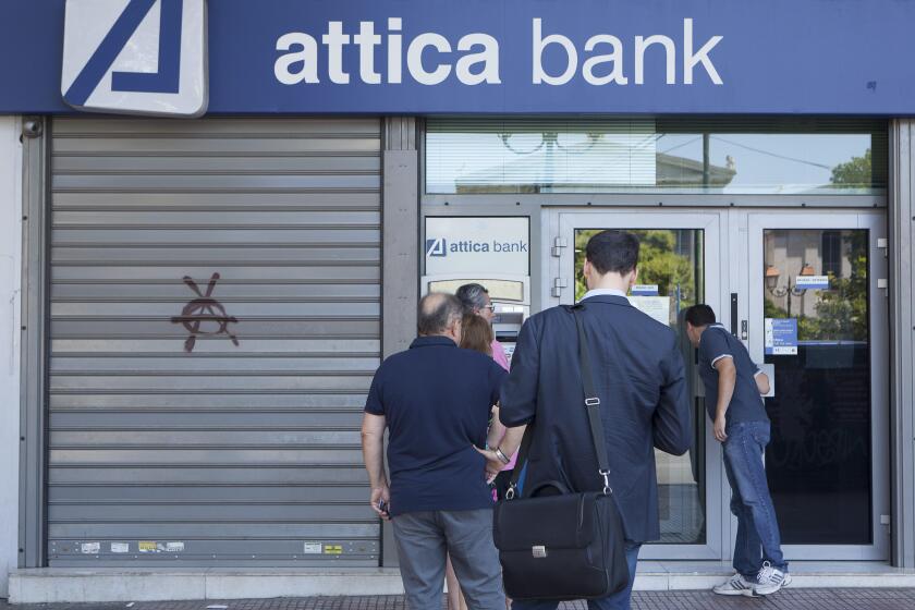 People line up at an ATM outside an Attica Bank branch in Athens, Greece on July 8, 2015.  Greece asked for more funds from the European Union as it prepared a last ditch effort on economic reforms to stay in the Euro before a fast-approaching deadline.  