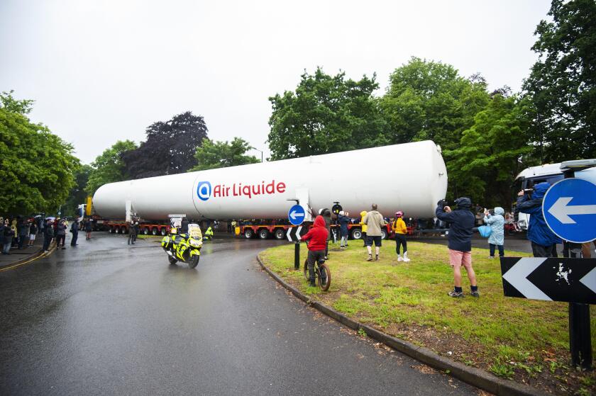 An empty colossal-sized ?Air Liquide? medical grade oxygen tank being transported on a 164ft (50m) lorry across Four Oaks, Sutton Coldfield.