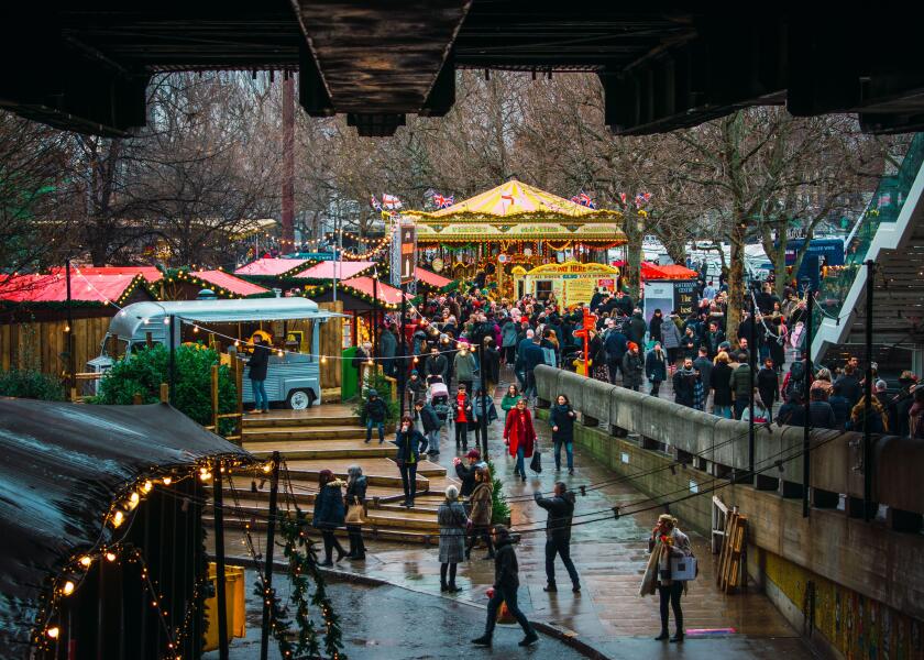 London, UK/Europe; 21/12/2019: Winter Christmas market in Southbank, London. People eating, drinking and having fun with friends and family.