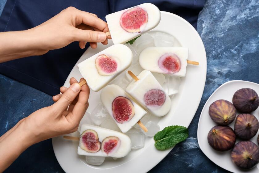 Woman with delicious fig ice-cream on color background