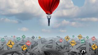 Easy way forward rise above confusion leadership concept with a businessman in a balloon flying and soaring over a complicated group of roads as a business metaphor of innovative creative thinking for success.