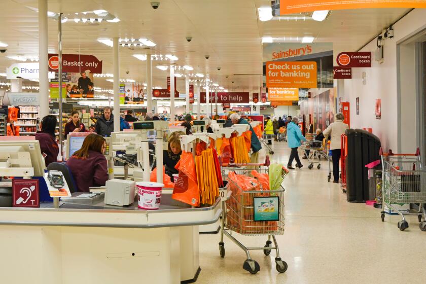 Checkout points and staff in a Sainsburys supermarket
