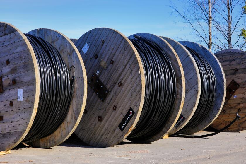 Prysmian Group Wiski Plain cable reels for ground installations at rural work site with blue sky background. Marttila, Finland. April 6, 2019.