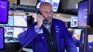 A trader works on the trading floor at the New York Stock Exchange (NYSE) in Manhattan, New York City, U.S., May 5, 2022. REUTERS/Andrew Kelly