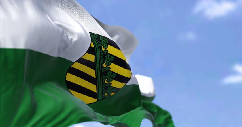 The flag of Saxony waving in the wind on a clear day