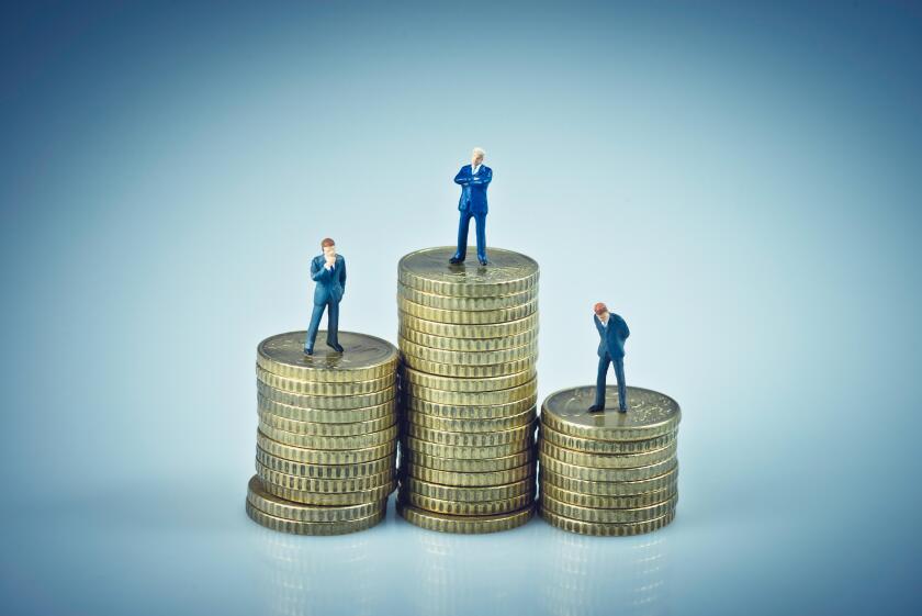 Financial concept. Business people standing on coins piles. Macro photo