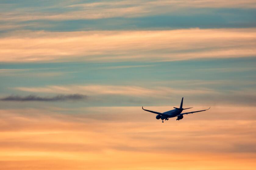 Airplane taking off in the sunset