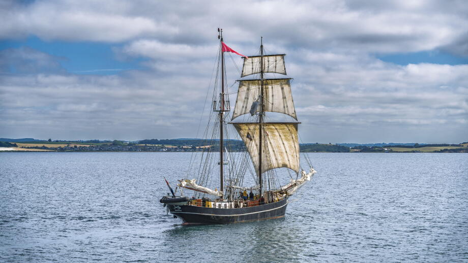 Classic maritime vessel in serene seascape.