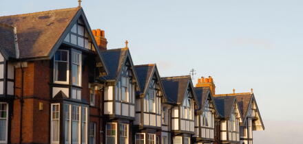 A row of large Edwardian style house rooftops in early morning sun at Scarborough