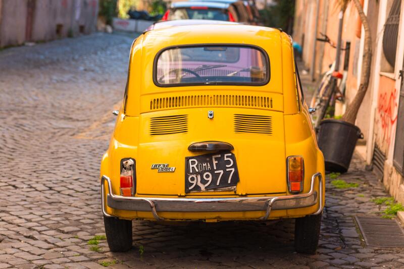 Two classic Fiat 500 cars parked on Trastevere backstreet, Rome, Lazio, Italy.