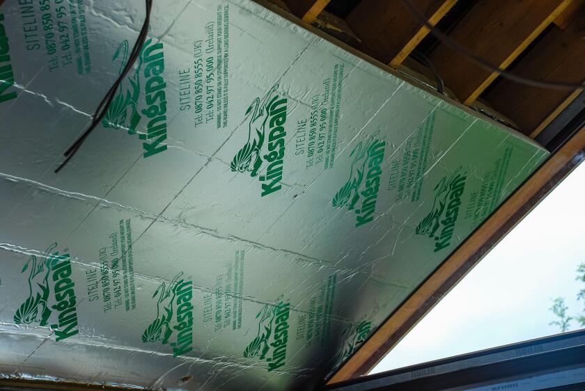 Kingspan insulation being installed on the inside of the roof of a sunroom.