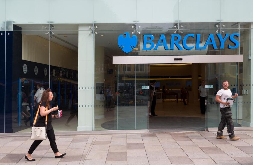 People outside Barclays bank one looking back at the other, Cardiff, Wales, UK