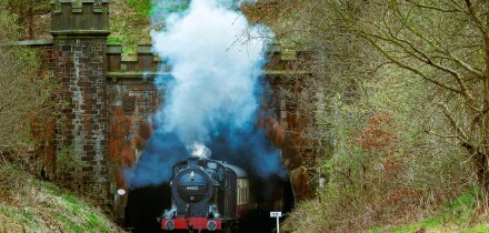 LMS 0-6-0 4F locomotive seen steaming from the Nuttall Park tunnel on the East Lancashire heritage railway towards Ramsbottom.