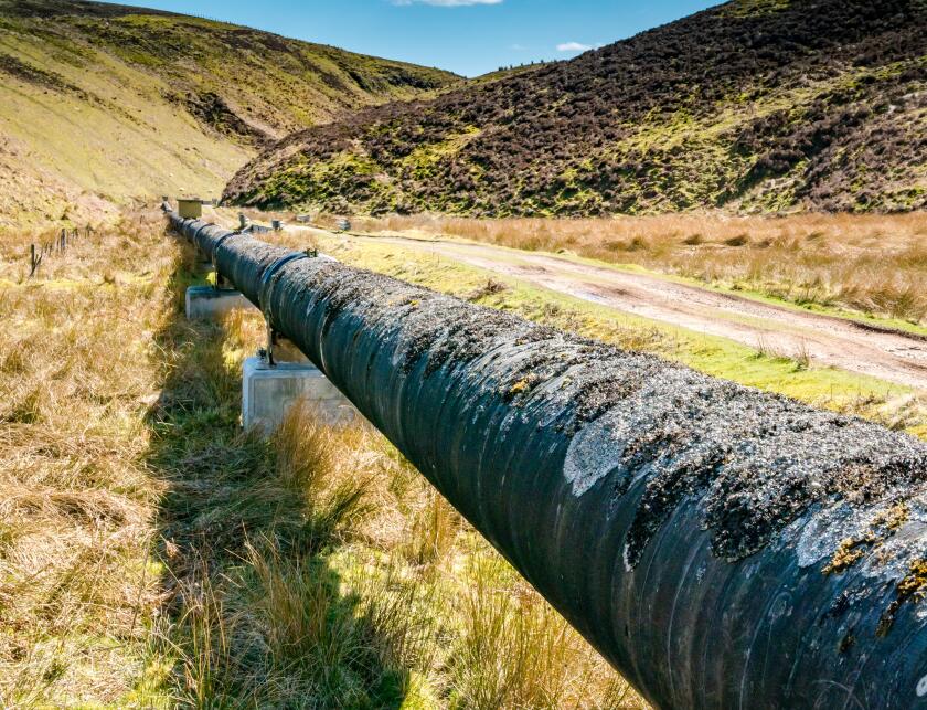 Long water pipe, Medwin Water valley, Scottish Borders, Scotland, UK on sunny Spring day