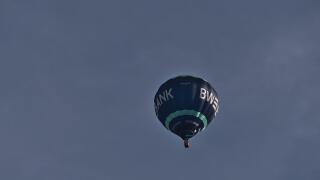 View of a blue and turquoise colored flying hot air balloon branded by public German bank Landesbank Baden-Wurttemberg (LBBW, BW Bank).