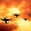 silhouette of drones in formation