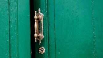old door ajar with ornate handle
