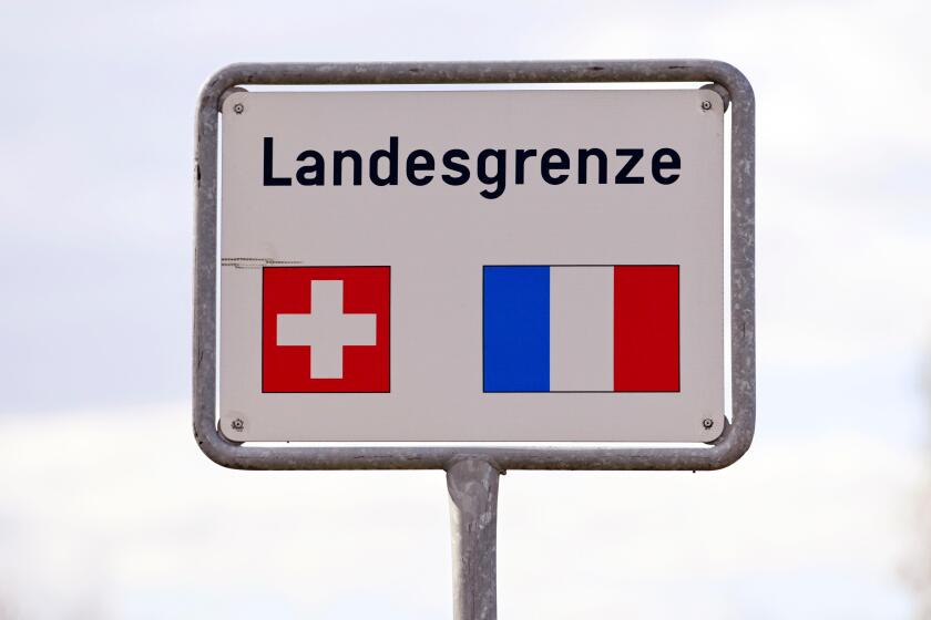 Sign National border with flags Switzerland, France. Image shot 2020. Exact date unknown.