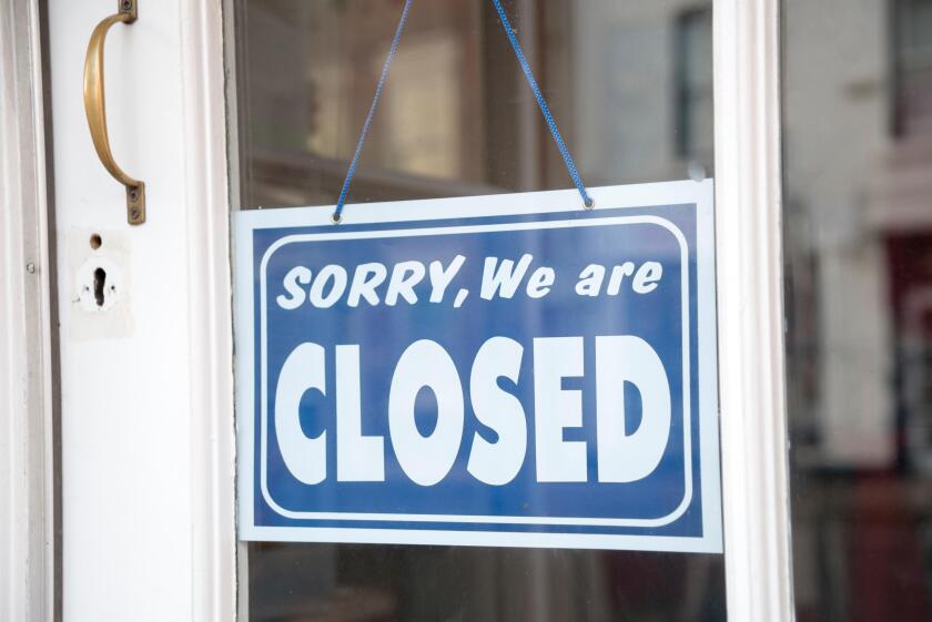 Closed sign on shop door, UK.