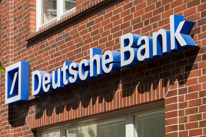 Stade, Germany - May 28, 2020: Signage on brick wall at Deutsche Bank branch . Deutsche Bank is a global Multinational Investment bank and financial s