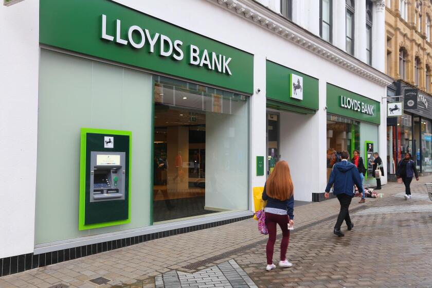 LEEDS, UK - JULY 11, 2016: People walk by Lloyds Bank in Leeds, UK. Lloyds Bank is a public limited company and is one of biggest banks in the UK.
