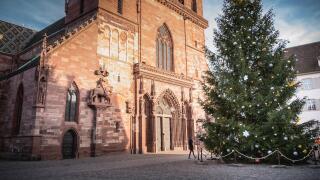 Basel, Switzerland - December 25, 2017: Architectural detail of the protestant cathedral emblem of the city decorated for Christmas