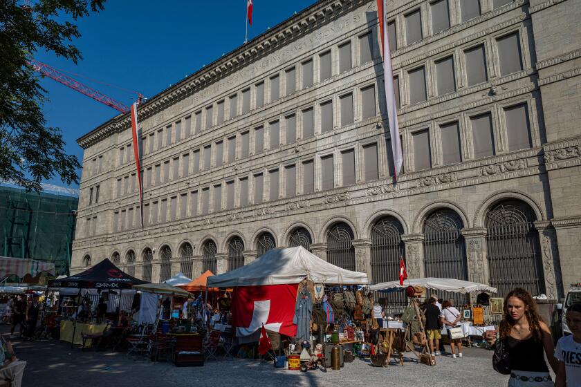 Swiss national bank in zurich with flea market in the foreground