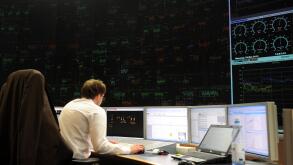 An employee sits in front of a computer screen in the electrical network security center at Amprion&nbsp;GmbH in Cologne, Germany, 29 May 2012. Photo: CAROLINE&nbsp;SEIDEL