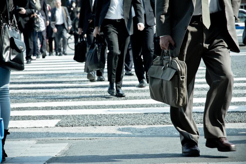 Low Section Of Business People Walking On Road