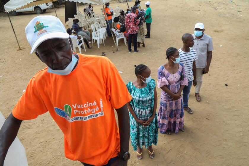People wait in line near a vaccination truck to receive a vaccine against the coronavirus disease (COVID-19) during the visit of Sandra Kramer, director for Africa at the Directorate General for International Partnerships (INTPA) of the European Commissio