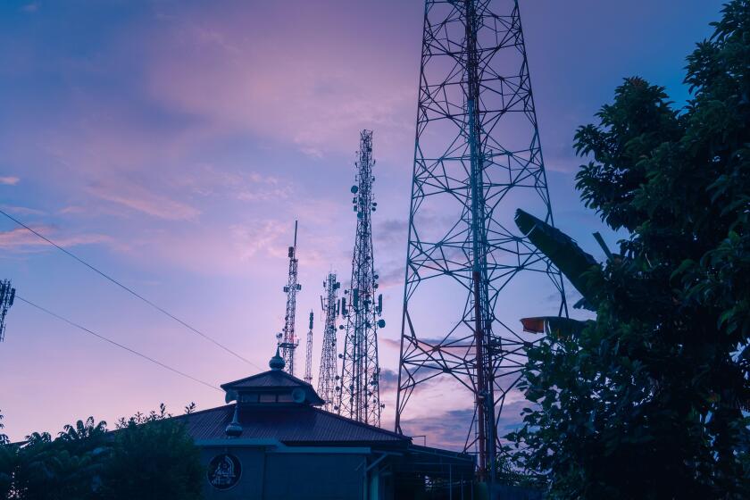 BTS tower pole or radio transmitter towering high into the sky in the morning