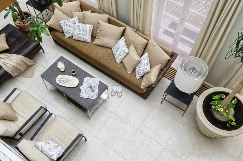 Meringues and tea on coffee table with chrome legs in front of Gervasoni rattan sofa with pillows and leather ottoman in orangery 


UK AND IRISH RIGH
