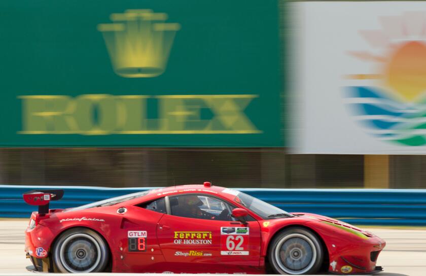 Red Ferarri racing at 12 Hours of Sebring Car race in Sebring Florida