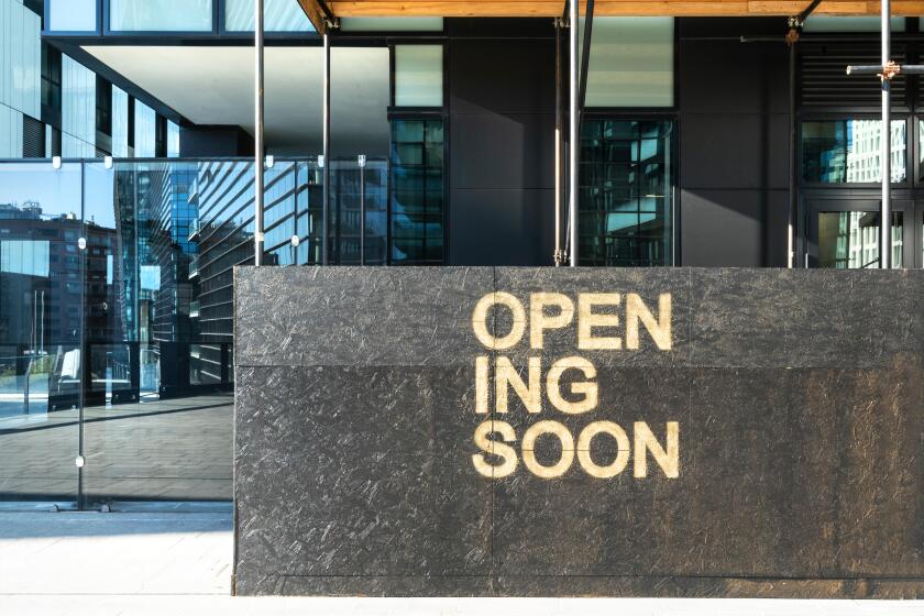 the writing Opening Soon in a building site in Milan, Italy