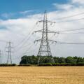 National Grid power lines cross arable fields near Nettleton in England's Cotswolds Hills.