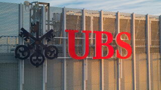 UBS logotype on the top of the UBS office during sunrise. UBS AG is a Swiss global financial services company with its headquarters in Zurich and Base
