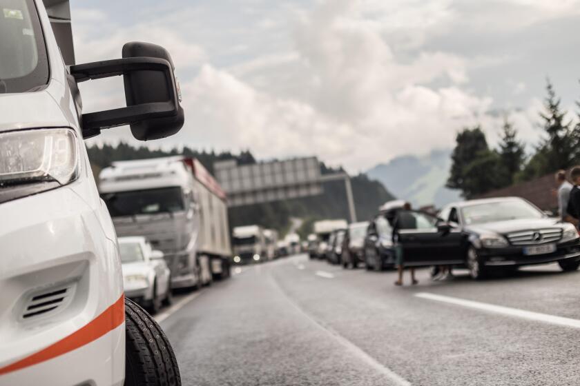 Typical scene on European highways during summer holiadays rush hour. A traffic jam with rows of cars tue to highway car accident. Empty emergency